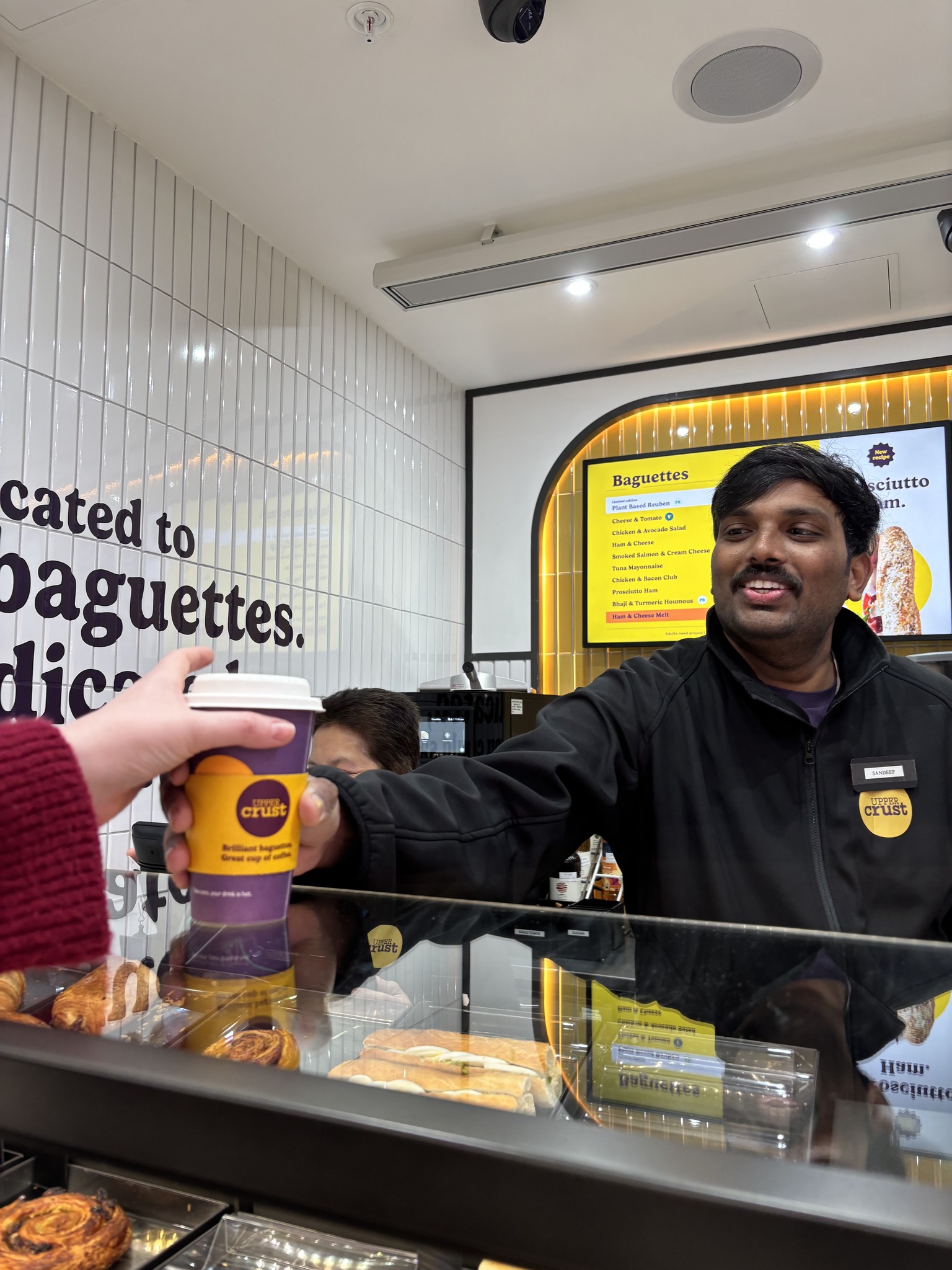 SSP worker handing coffee to customer